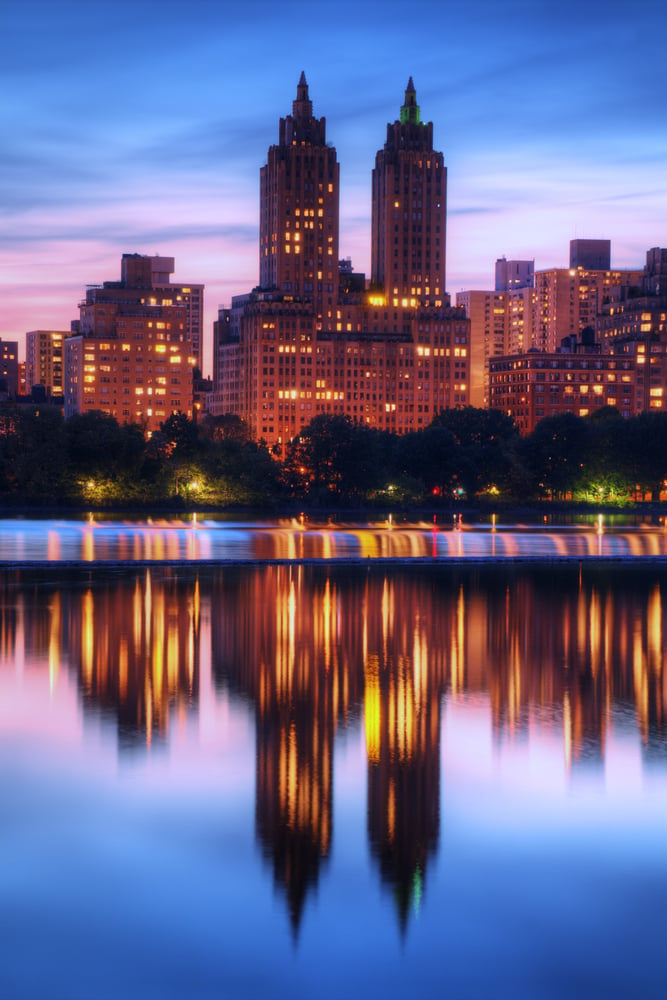 Skyline of buildings along Central Park West viewed from above Jackie Kennedy Onassis Reservoir in New York City.